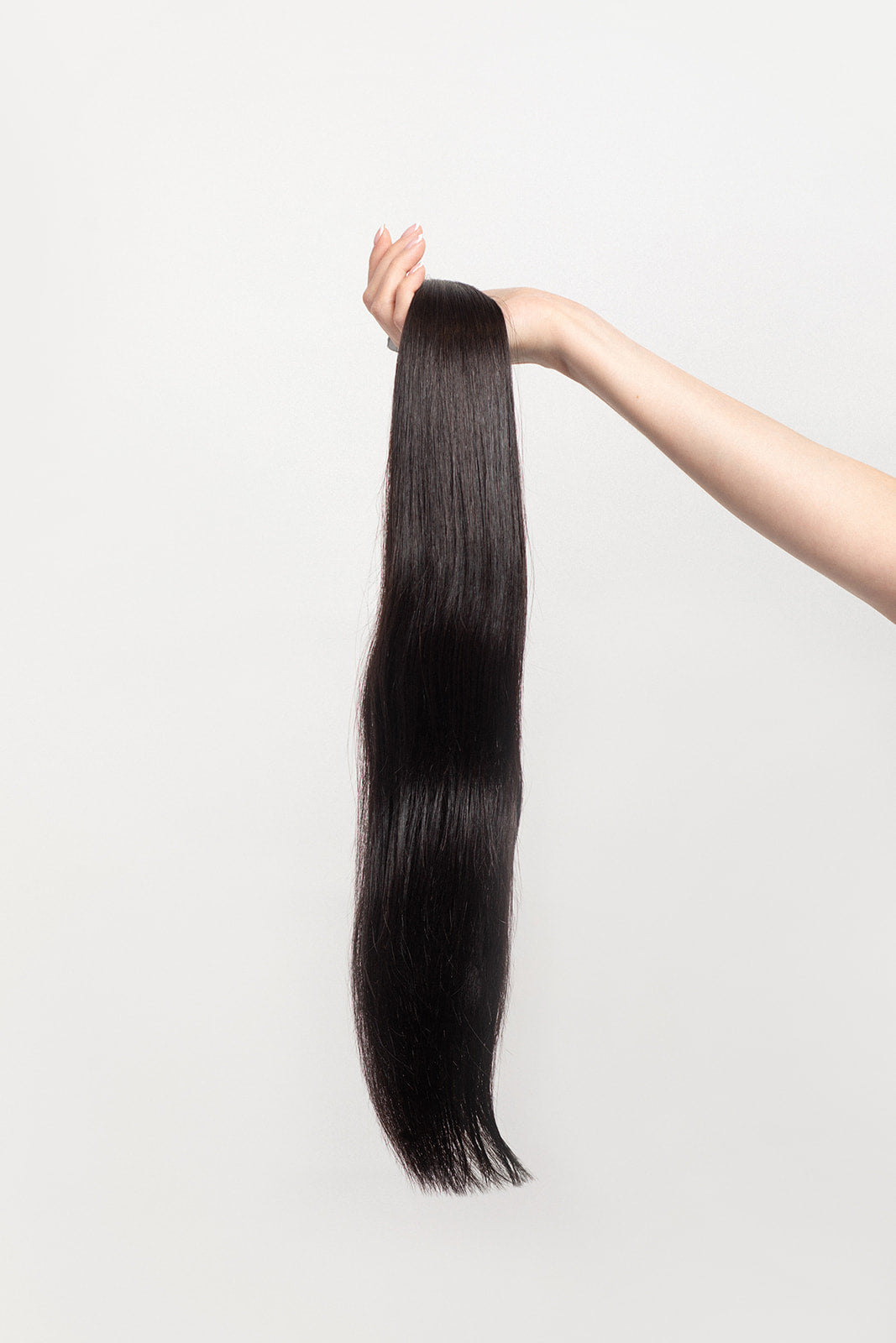Nightfall is our darkest brown with cool undertones. Envision indulging in a 90% Cocoa Dark Chocolate bar - with zero calories.  Stylist lingo: Natural level 3/4 Harloc Tape-In Extensions are made from ethically sourced, premium, Remy Slavic Hair. These reusable hair extensions can be used to add length, volume, chemical-free colour, or to correct or enhance a haircut. Available in 16 beautiful shades. Combine multiple colours to create a custom colour blend and perfect match.