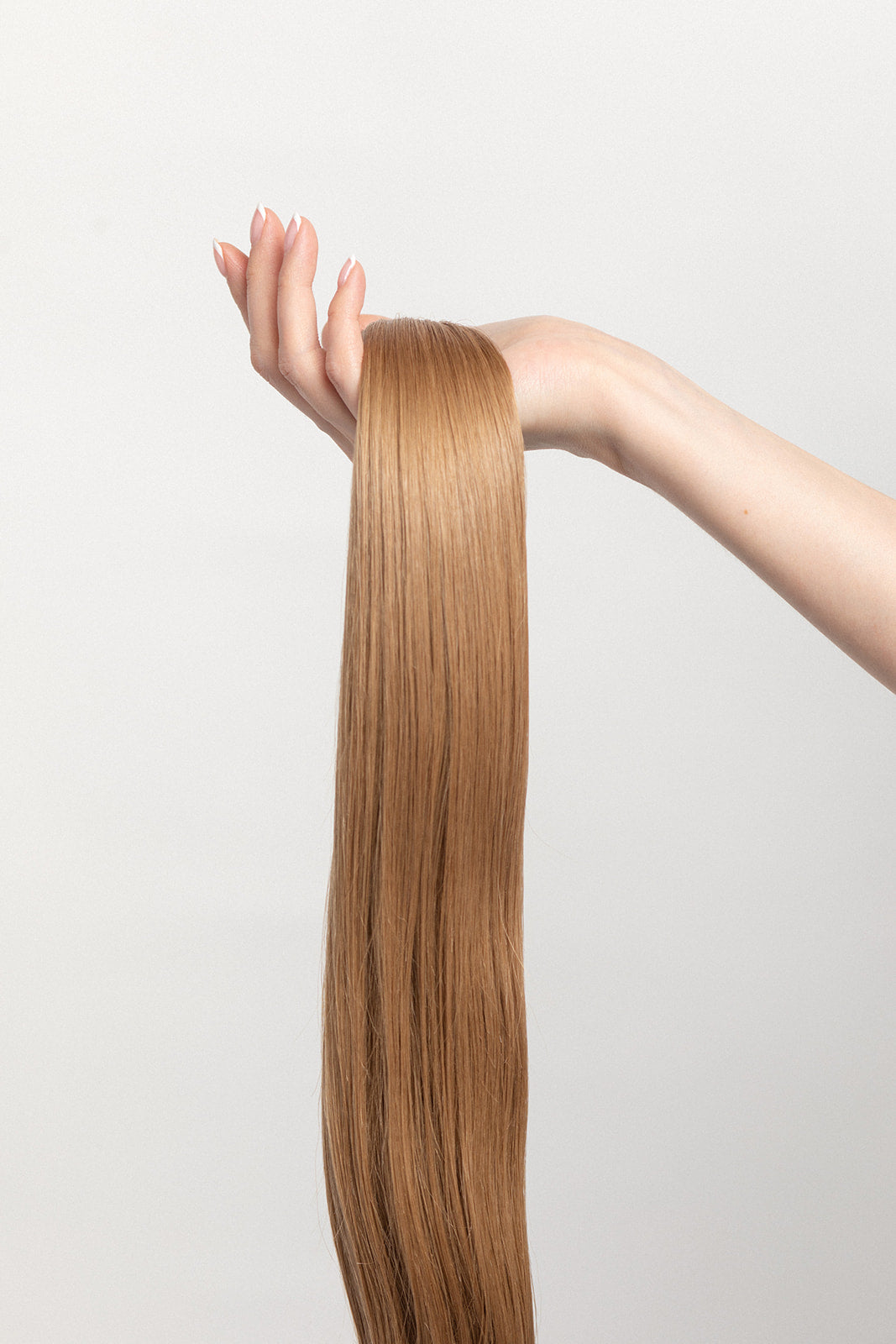 Sand is our darkest blonde with cool reflections. Wear it on its own or to perfectly compliment any highlight. Stylist lingo: Natural/beige level 8  Harloc Tape-In Extensions are made from ethically sourced, premium, Remy Slavic Hair. These reusable hair extensions can be used to add length, volume, chemical-free colour, or to correct or enhance a haircut. Available in 16 beautiful shades. Combine multiple colours to create a custom colour blend and perfect match.