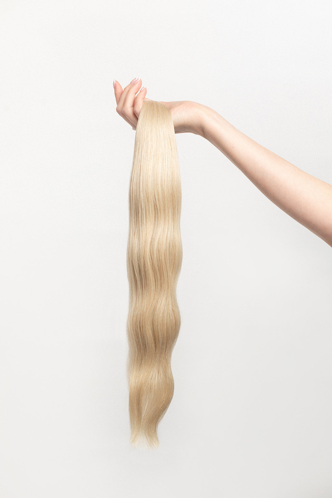 Pearl is our ashy blonde, bright but opalescent. A hard exterior with a soft demeanor. The world is your oyster.  Stylist lingo: Ash level 10 Harloc Tape-In Extensions are made from ethically sourced, premium, Remy Slavic Hair. These reusable hair extensions can be used to add length, volume, chemical-free colour, or to correct or enhance a haircut. Available in 16 beautiful shades. Combine multiple colours to create a custom colour blend and perfect match.