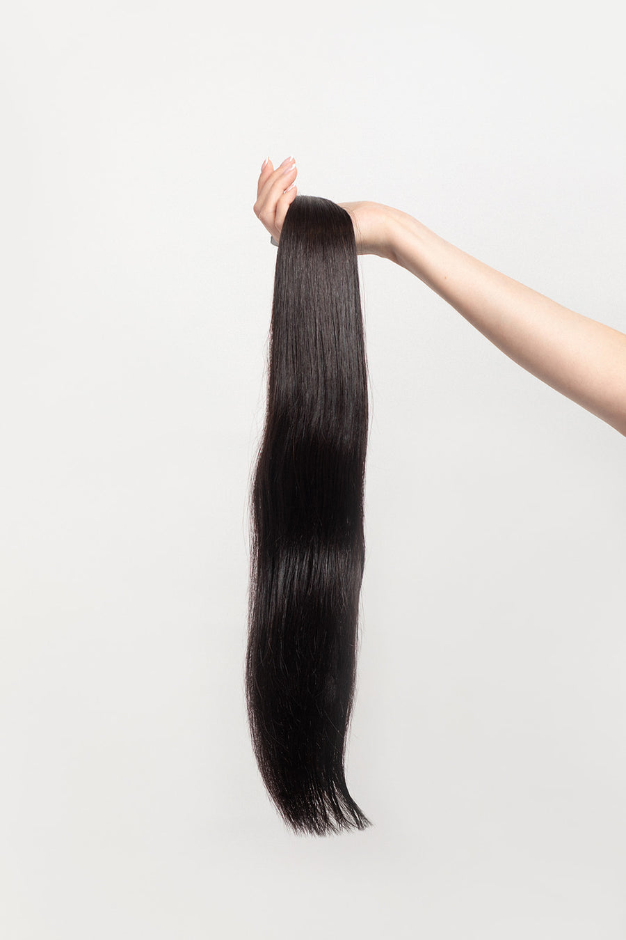 Nightfall is our darkest brown with cool undertones. Envision indulging in a 90% Cocoa Dark Chocolate bar - with zero calories.  Stylist lingo: Natural level 3/4 Harloc Tape-In Extensions are made from ethically sourced, premium, Remy Slavic Hair. These reusable hair extensions can be used to add length, volume, chemical-free colour, or to correct or enhance a haircut. Available in 16 beautiful shades. Combine multiple colours to create a custom colour blend and perfect match.