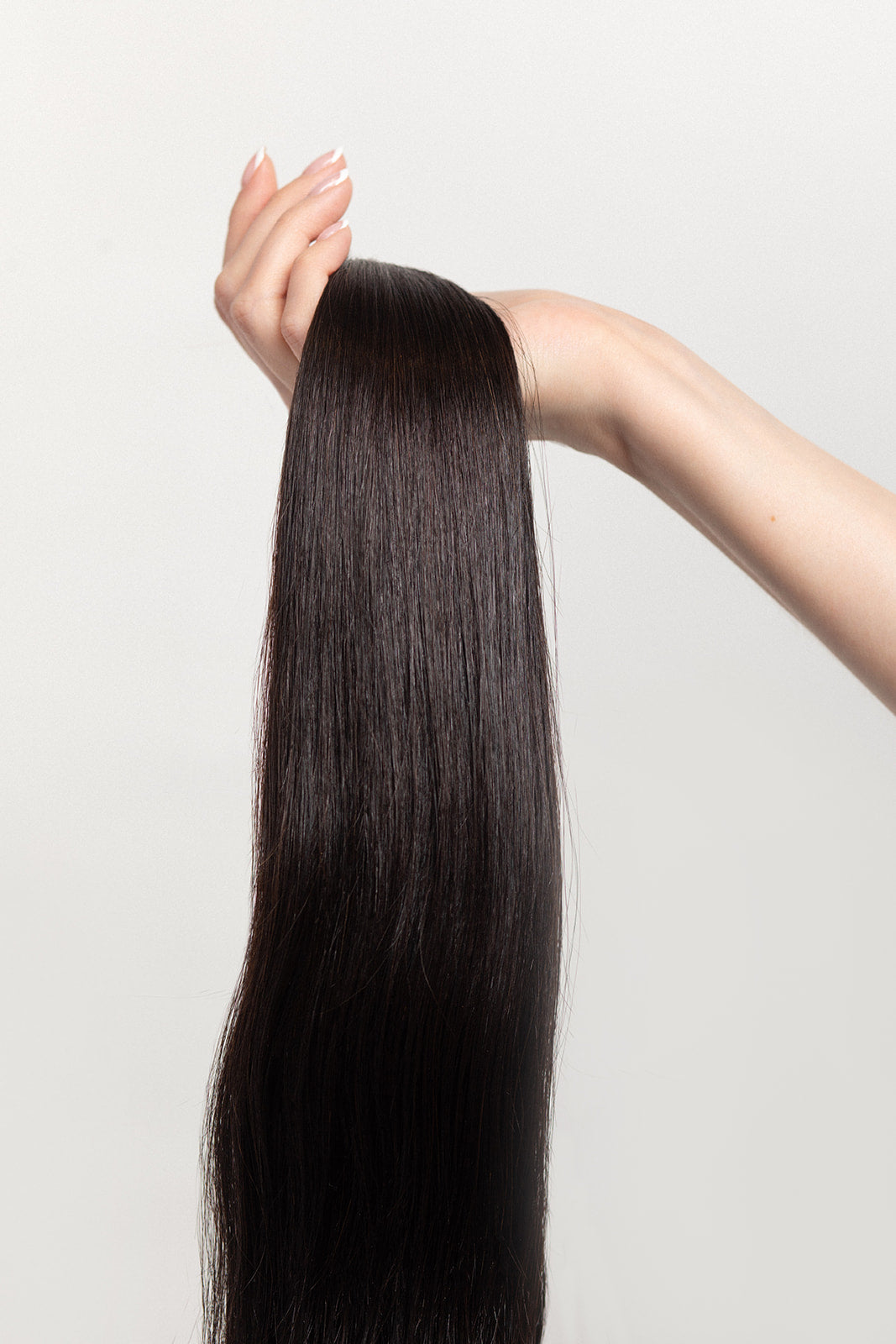 Nightfall is our darkest brown with cool undertones. Envision indulging in a 90% Cocoa Dark Chocolate bar - with zero calories.  Stylist lingo: Natural level 3/4 Harloc Tape-In Extensions are made from ethically sourced, premium, Remy Slavic Hair. These reusable hair extensions can be used to add length, volume, chemical-free colour, or to correct or enhance a haircut. Available in 16 beautiful shades. Combine multiple colours to create a custom colour blend and perfect match.
