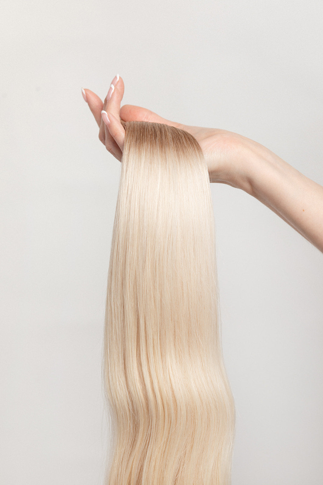 Vetiver Vanilla is our icy blonde, blended out from a Sand root.  Stylist lingo: Natural rooted level 8 blended into an icy level 10  Harloc Tape-In Extensions are made from ethically sourced, premium, Remy Slavic Hair. These reusable hair extensions can be used to add length, volume, chemical-free colour, or to correct or enhance a haircut. Available in 16 beautiful shades. Combine multiple colours to create a custom colour blend and perfect match.