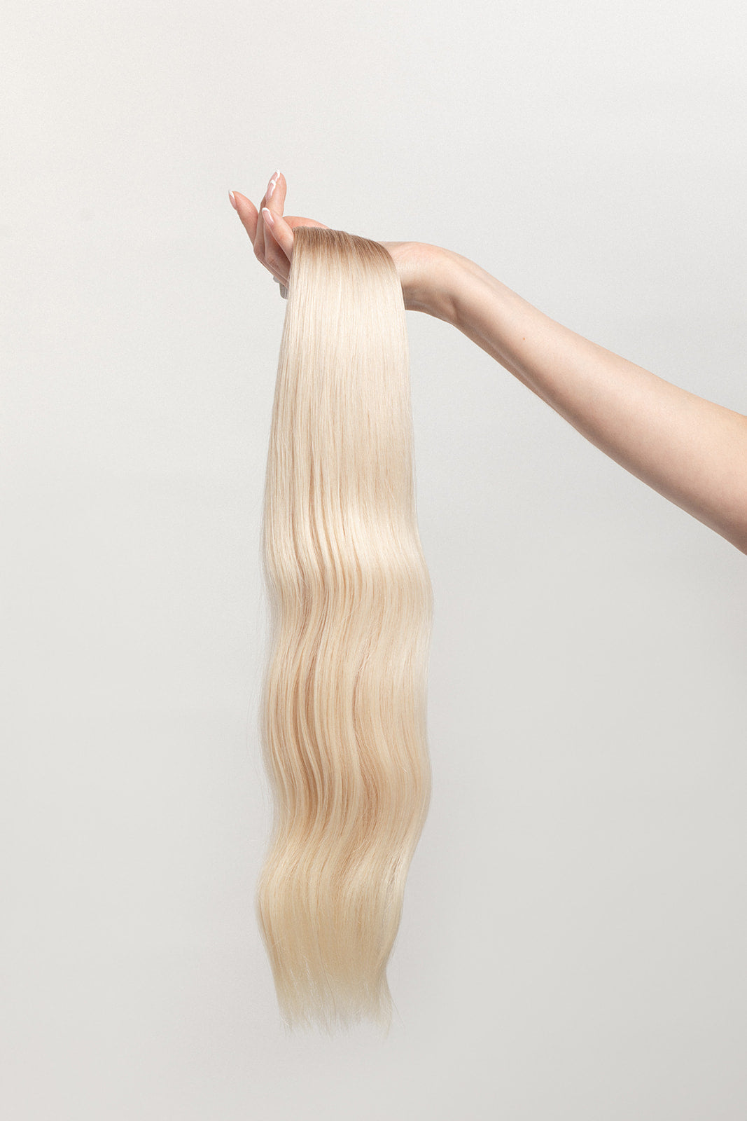 Vetiver Vanilla is our icy blonde, blended out from a Sand root.  Stylist lingo: Natural rooted level 8 blended into an icy level 10  Harloc Tape-In Extensions are made from ethically sourced, premium, Remy Slavic Hair. These reusable hair extensions can be used to add length, volume, chemical-free colour, or to correct or enhance a haircut. Available in 16 beautiful shades. Combine multiple colours to create a custom colour blend and perfect match.