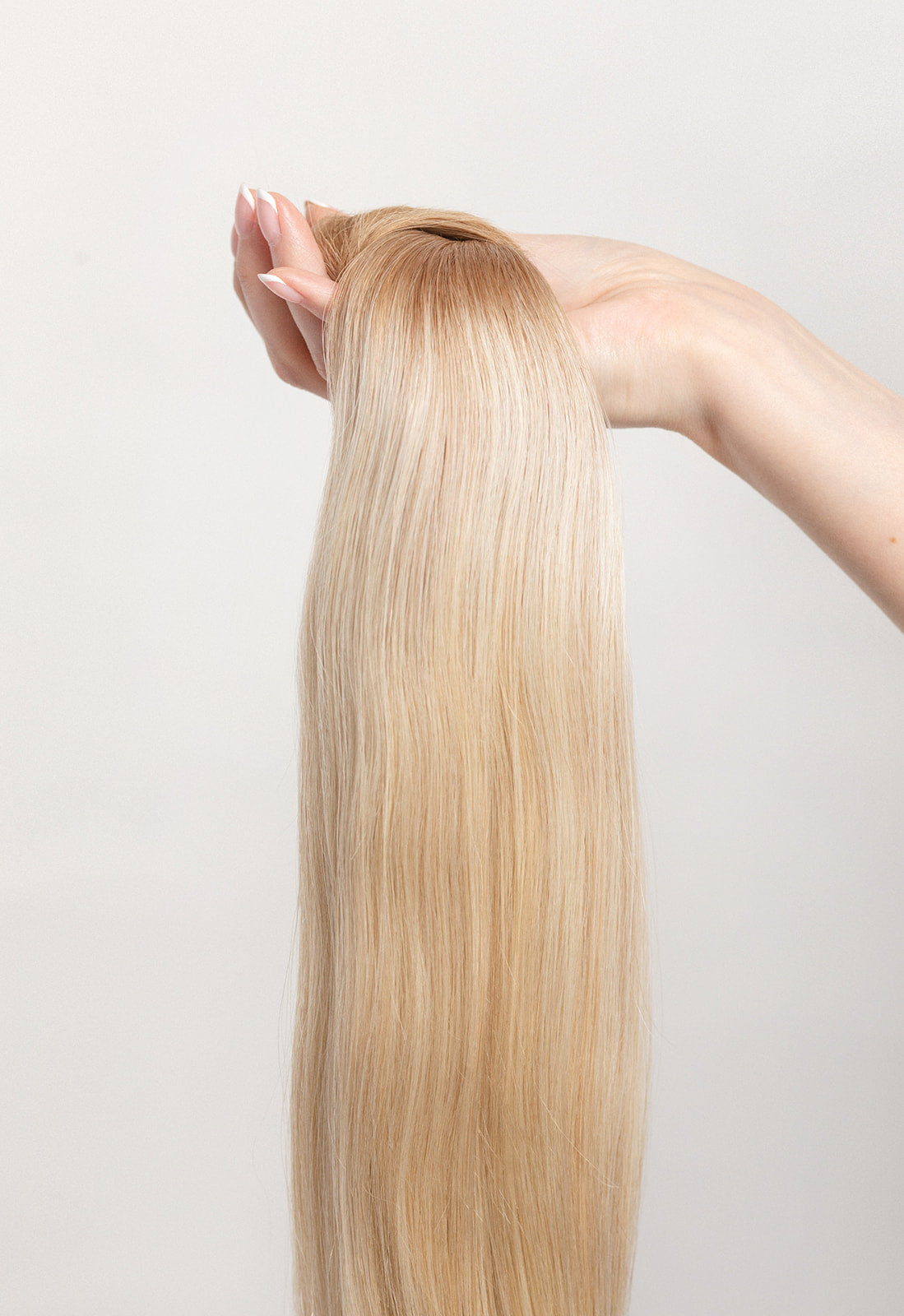 Soleil Sand is our golden blonde blend cascading from a Sand root.  Stylist lingo: Natural rooted level 8 blended into natural/gold dimensional levels 8 &amp; 10 Hidden Harloc Clip-In Extensions are made from ethically sourced, Remy Slavic hair. They come with 5 seamless silicone wefts to ensure an undetectable result that is comfortable to wear. Whether you are looking to add volume or length, a stunning look for a special event, or just want to look and feel gorgeous. Available in 10 of our beautiful shades.
