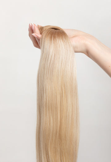 Soleil Sand is our golden blonde blend cascading from a Sand root.  Stylist lingo: Natural rooted level 8 blended into natural/gold dimensional levels 8 & 10 The Harloc Ponytail Extension is our clip-in ponytail that is made from ethically sourced, Remy Slavic hair. It is a quick way to instantly add length and volume to your ponytail and it comes in two lengths, 18-20” and 20-24”. It comes with a velcro base and clip to secure the ponytail.  Available in 10 of our beautiful shades.