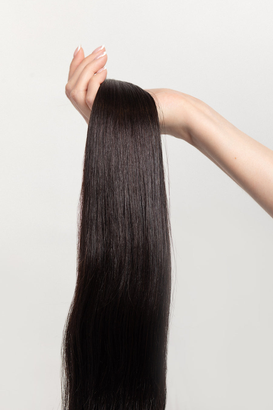 Nightfall is our darkest brown with cool undertones. Envision indulging in a 90% Cocoa Dark Chocolate bar - with zero calories.  Stylist lingo: Natural level 3/4 Harloc Tape-In Extensions are made from ethically sourced, premium, Remy Slavic Hair. These reusable hair extensions can be used to add length, volume, chemical-free colour, or to correct or enhance a haircut. Available in 16 beautiful shades. Combine multiple colours to create a custom colour blend and perfect match.