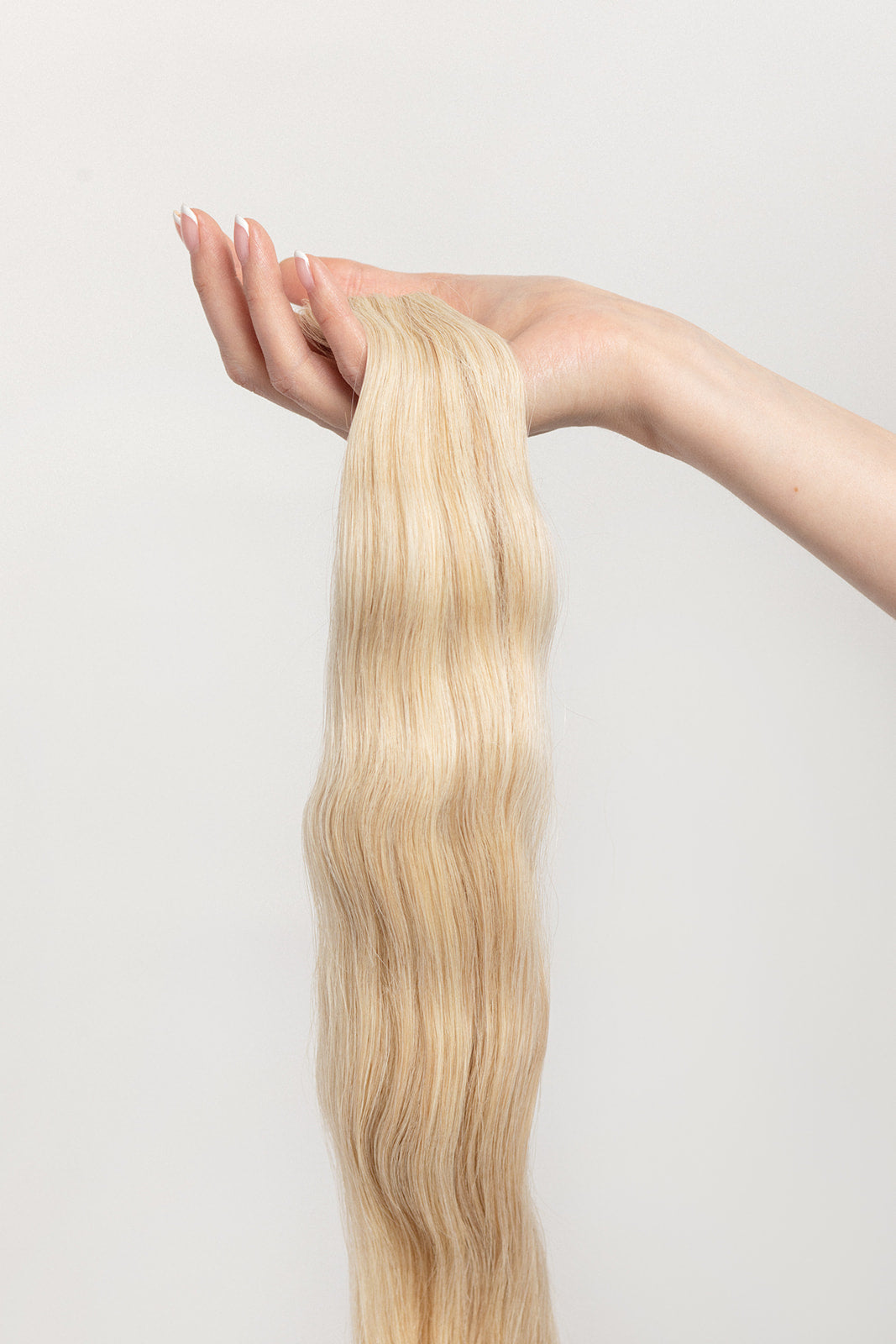 Honey is our dimensional blonde with warm undertones. This will have you feeling sweet like honey but stinging like a bee.   Stylist lingo: Natural/gold dimensional mix of levels 9 & 10 Harloc Tape-In Extensions are made from ethically sourced, premium, Remy Slavic Hair. These reusable hair extensions can be used to add length, volume, chemical-free colour, or to correct or enhance a haircut. Available in 16 beautiful shades. Combine multiple colours to create a custom colour blend and perfect match.