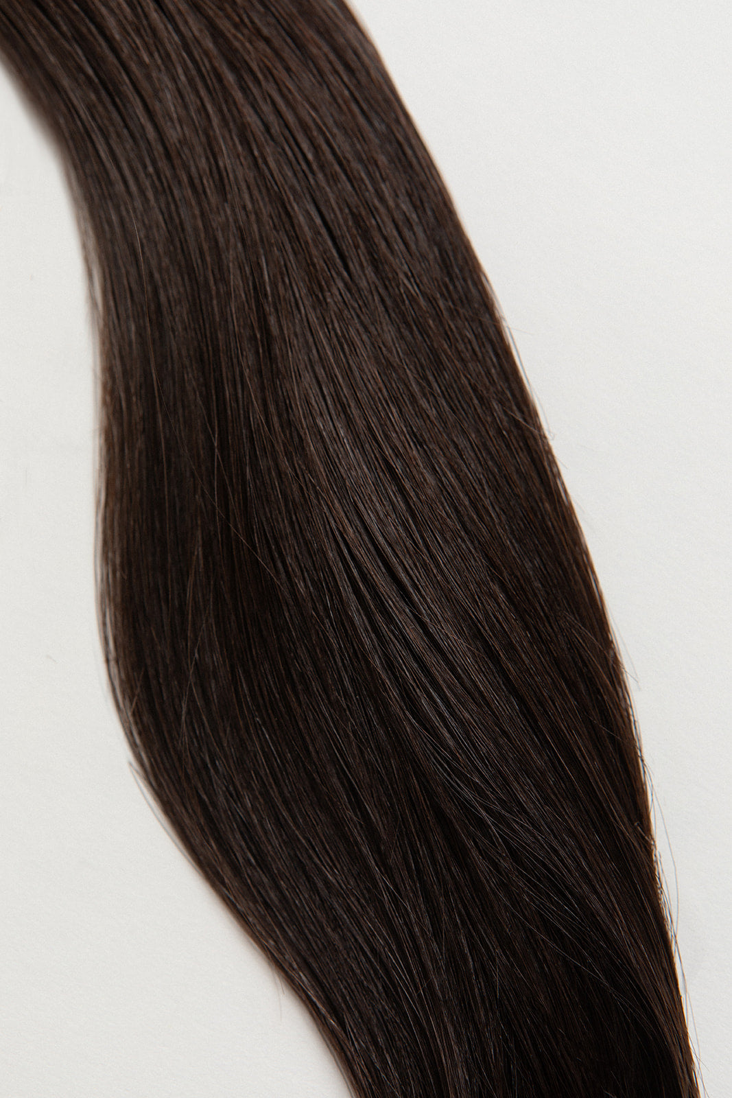 Shade is our dark brown with cool and warm undertones. Stylist lingo: Natural level 5 Hidden Harloc Clip-In Extensions are made from ethically sourced, Remy Slavic hair. They come with 5 seamless silicone wefts to ensure an undetectable result that is comfortable to wear. Whether you are looking to add volume or length, a stunning look for a special event, or just want to look and feel gorgeous. Available in 10 of our beautiful shades.