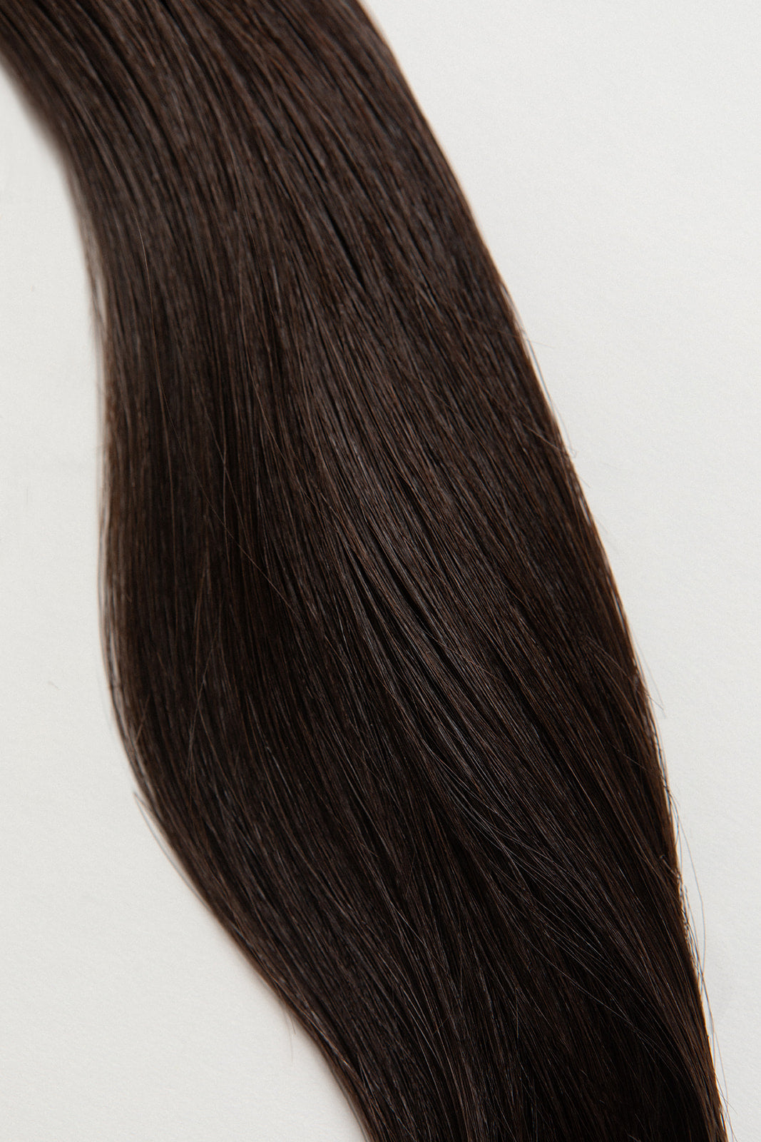 Shade is our dark brown with cool and warm undertones. Stylist lingo: Natural level 5 The Harloc Ponytail Extension is our clip-in ponytail that is made from ethically sourced, Remy Slavic hair. It is a quick way to instantly add length and volume to your ponytail and it comes in two lengths, 18-20” and 20-24”. It comes with a velcro base and clip to secure the ponytail. Available in 10 of our beautiful shades.