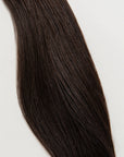 Shade is our dark brown with cool and warm undertones. Stylist lingo: Natural level 5 The Harloc Ponytail Extension is our clip-in ponytail that is made from ethically sourced, Remy Slavic hair. It is a quick way to instantly add length and volume to your ponytail and it comes in two lengths, 18-20” and 20-24”. It comes with a velcro base and clip to secure the ponytail. Available in 10 of our beautiful shades.