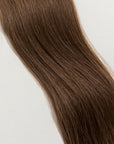 Walnut is our light brown, with cool yet rich undertones. Stylist lingo: Natural level 7 The Harloc Ponytail Extension is our clip-in ponytail that is made from ethically sourced, Remy Slavic hair. It is a quick way to instantly add length and volume to your ponytail and it comes in two lengths, 18-20” and 20-24”. It comes with a velcro base and clip to secure the ponytail. Available in 10 of our beautiful shades.