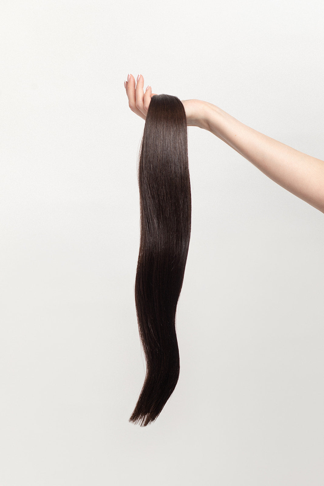 Shade is our dark brown with cool and warm undertones. Stylist lingo: Natural level 5 The Harloc Ponytail Extension is our clip-in ponytail that is made from ethically sourced, Remy Slavic hair. It is a quick way to instantly add length and volume to your ponytail and it comes in two lengths, 18-20” and 20-24”. It comes with a velcro base and clip to secure the ponytail. Available in 10 of our beautiful shades.