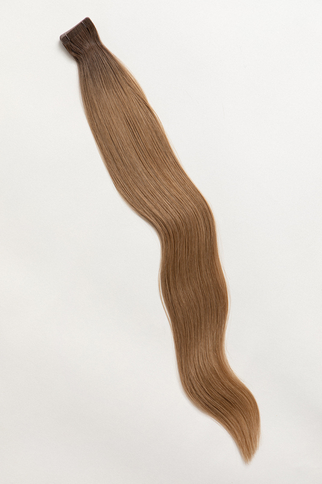 Smoked Topaz is our rooted, neutral brunette blend. Stylist lingo: Natural rooted level 6 blended into a natural/beige level 8 Harloc Tape-In Extensions are made from ethically sourced, premium, Remy Slavic Hair. These reusable hair extensions can be used to add length, volume, chemical-free colour, or to correct or enhance a haircut. Available in 16 beautiful shades. Combine multiple colours to create a custom colour blend and perfect match.