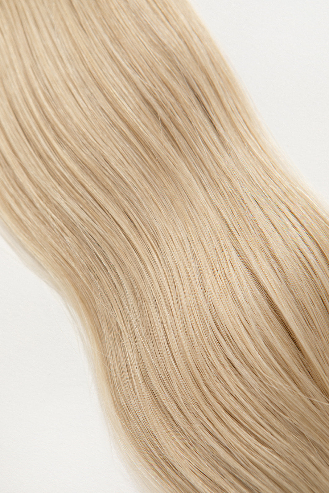 Pearl is our ashy blonde, bright but opalescent. A hard exterior with a soft demeanor. The world is your oyster.  Stylist lingo: Ash level 10 Harloc Tape-In Extensions are made from ethically sourced, premium, Remy Slavic Hair. These reusable hair extensions can be used to add length, volume, chemical-free colour, or to correct or enhance a haircut. Available in 16 beautiful shades. Combine multiple colours to create a custom colour blend and perfect match.