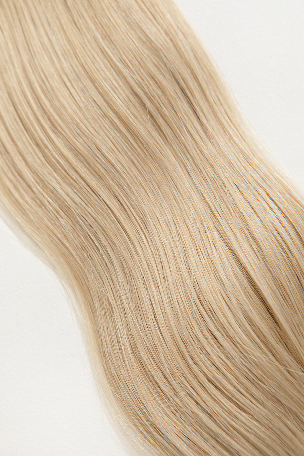 Pearl is our ashy blonde, bright but opalescent.  Stylist lingo: Ash level 10 Hidden Harloc Clip-In Extensions are made from ethically sourced, Remy Slavic hair. They come with 5 seamless silicone wefts to ensure an undetectable result that is comfortable to wear. Whether you are looking to add volume or length, a stunning look for a special event, or just want to look and feel gorgeous . Available in 10 of our beautiful shades.