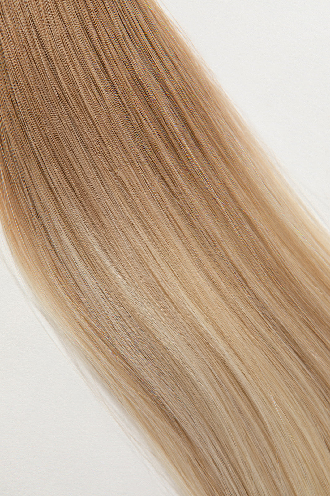 Soleil Sand is our golden blonde blend cascading from a Sand root.  Stylist lingo: Natural rooted level 8 blended into natural/gold dimensional levels 8 & 10 Hidden Harloc Clip-In Extensions are made from ethically sourced, Remy Slavic hair. They come with 5 seamless silicone wefts to ensure an undetectable result that is comfortable to wear. Whether you are looking to add volume or length, a stunning look for a special event, or just want to look and feel gorgeous. Available in 10 of our beautiful shades.
