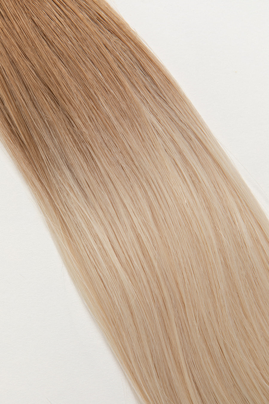 Vetiver Vanilla is our icy blonde, blended out from a Sand root.  Stylist lingo: Natural rooted level 8 blended into an icy level 10  Harloc Tape-In Extensions are made from ethically sourced, premium, Remy Slavic Hair. These reusable hair extensions can be used to add length, volume, chemical-free colour, or to correct or enhance a haircut. Available in 16 beautiful shades. Combine multiple colours to create a custom colour blend and perfect match.