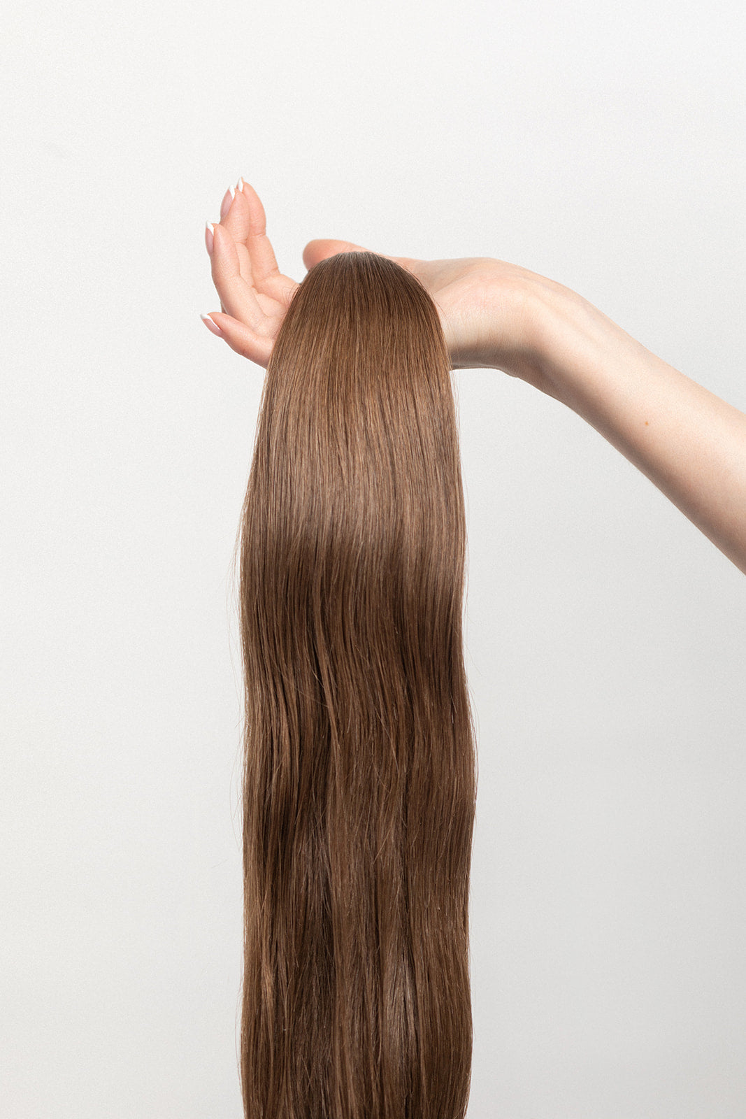 Walnut is our light brown, with cool yet rich undertones. Stylist lingo: Natural level 7 The Harloc Ponytail Extension is our clip-in ponytail that is made from ethically sourced, Remy Slavic hair. It is a quick way to instantly add length and volume to your ponytail and it comes in two lengths, 18-20” and 20-24”. It comes with a velcro base and clip to secure the ponytail. Available in 10 of our beautiful shades.